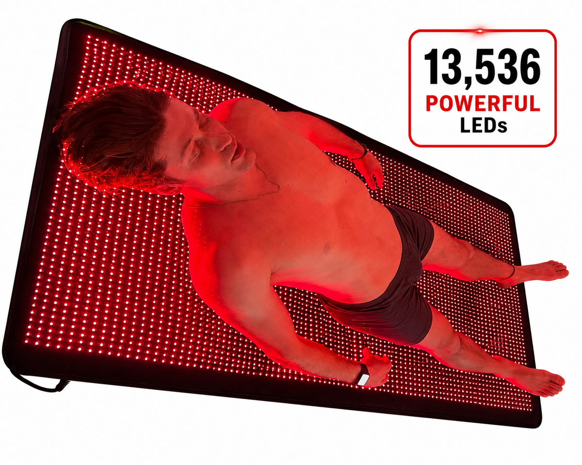 Person lying on a red light therapy mat with 13,536 LEDs.